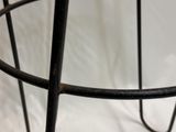 a metal basket with a black handle on a white background