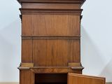 a wooden cabinet with a door open on a wooden floor