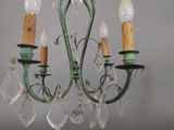 a chandelier with three lights hanging from the ceiling