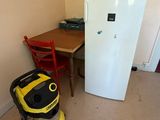 a yellow vacuum cleaner in the corner of a room