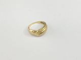 a close up of a gold ring on a white surface