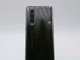 a close up of a phone on a stand on a white surface