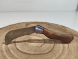a knife that is sitting on top of a piece of wood
