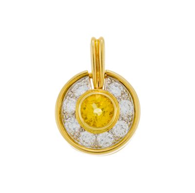 a yellow sapphire and diamond pendant on a white background