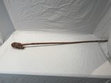 a wooden stick sitting on top of a white sheet