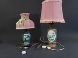 two lamps with pink shades and a pink shade on a black background