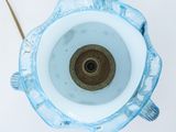underside view of a blue glass vase with a gold rim