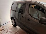 a small van parked in a garage next to a garage door