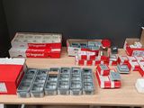 many boxes of cigarettes on a table with a lot of them