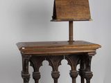 an old wooden chair with a wooden seat on top of a wooden table