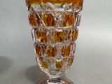 a glass vase that is sitting on a table