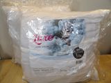 a bag of white pillows on a table in a room