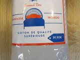 the pillow is white and has a blue and orange design on it