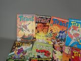 a lot of comic books that are on the table
