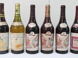 several bottles of wine are lined up in a row on a table