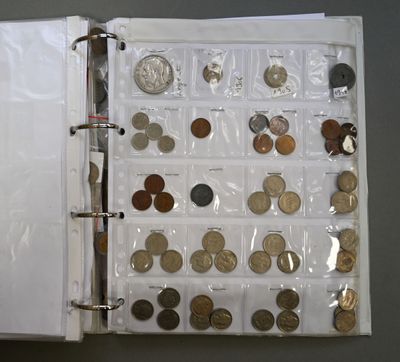 a white binder with coins in it on a table