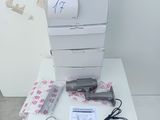 a stack of printers sitting on a table next to a printer