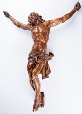 an antique wooden crucifix of jesus hanging on a wall