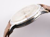 an image of a close up of a watch on a white surface