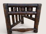a wooden chair that has a wooden seat on it