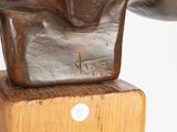 statue of a man with a hat on a wooden base