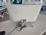 a computer monitor sitting on top of a desk with a mouse