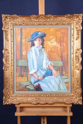 un tableau représentant une femme assise devant un chevalet en bois