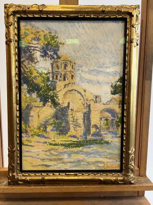 an oil painting of a church in a wooden frame on a table