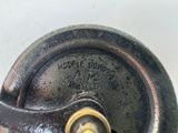 a close up of a metal object on a white surface