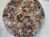 three plates with flowers on them on a table
