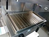 an oven with a rack on top of it in a kitchen