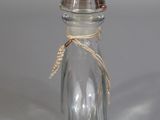 a small glass bottle with a small sail inside of it