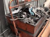 a pile of junk in a metal box next to a building