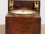 a small wooden box with a clock on it