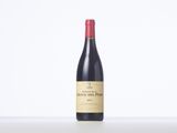 a bottle of red wine sitting on top of a table