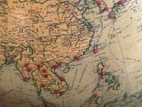 a large globe with red dots on it sitting on a table
