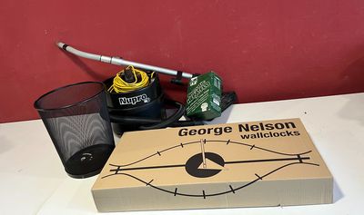 a box with a pen, a glass and a cigarette on a table