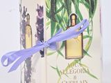 a box of perfume with a blue ribbon tied to it