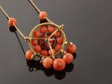 an image of a necklace with coral beads and a pentagram