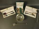 a silverware set with a spoon, fork and spoon rest in a box