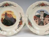 two plates with a picture of a castle on them on a table