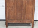 a wooden cabinet with a door on the top of it