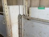 a metal door that is open in a building