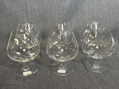three empty wine glasses sitting next to each other on a table