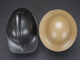 two black and tan bowls sitting next to each other on top of a table