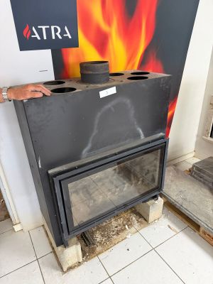 a man that is standing next to a fire place