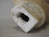 a close up of a vase with a hole in it