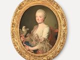 portrait of a woman holding a bird in a gold frame