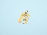 a close up of a small gold plated pendant on a blue surface