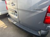 a silver van that is parked in a parking lot